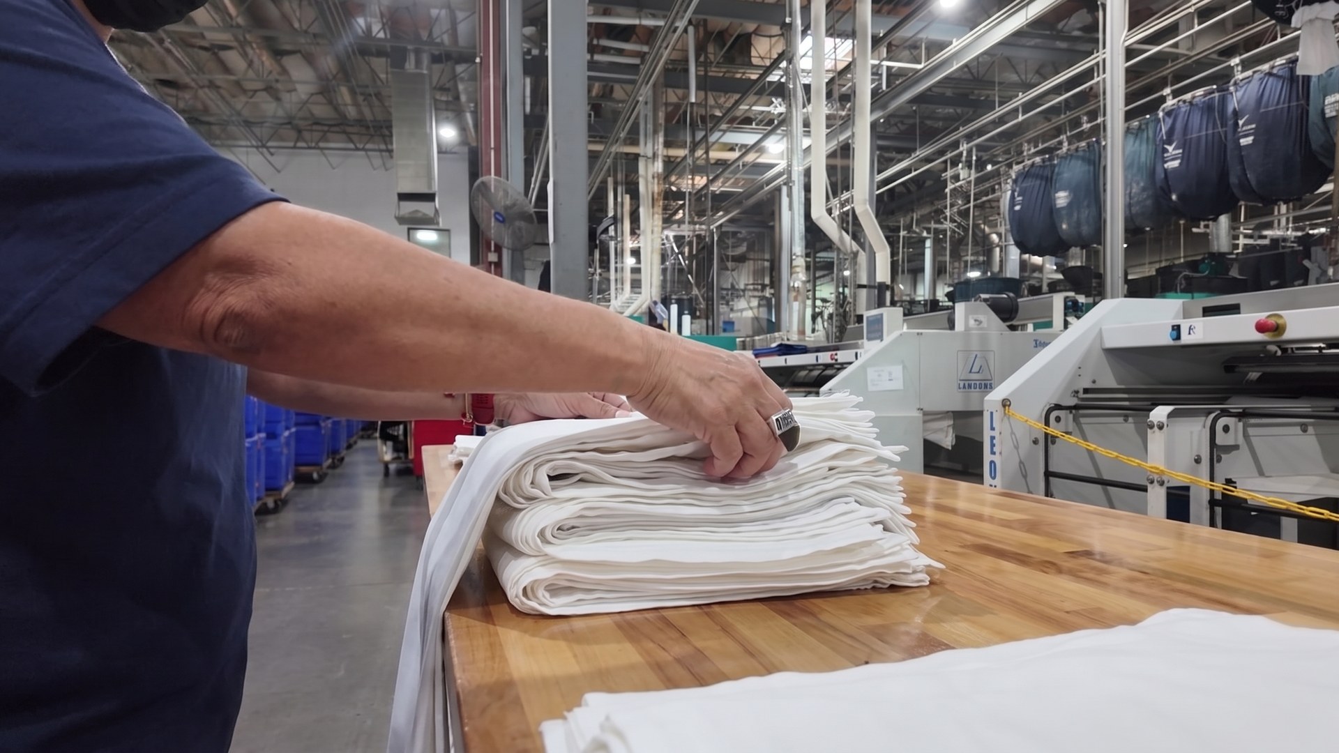 Commercial linen moving through the finishing process